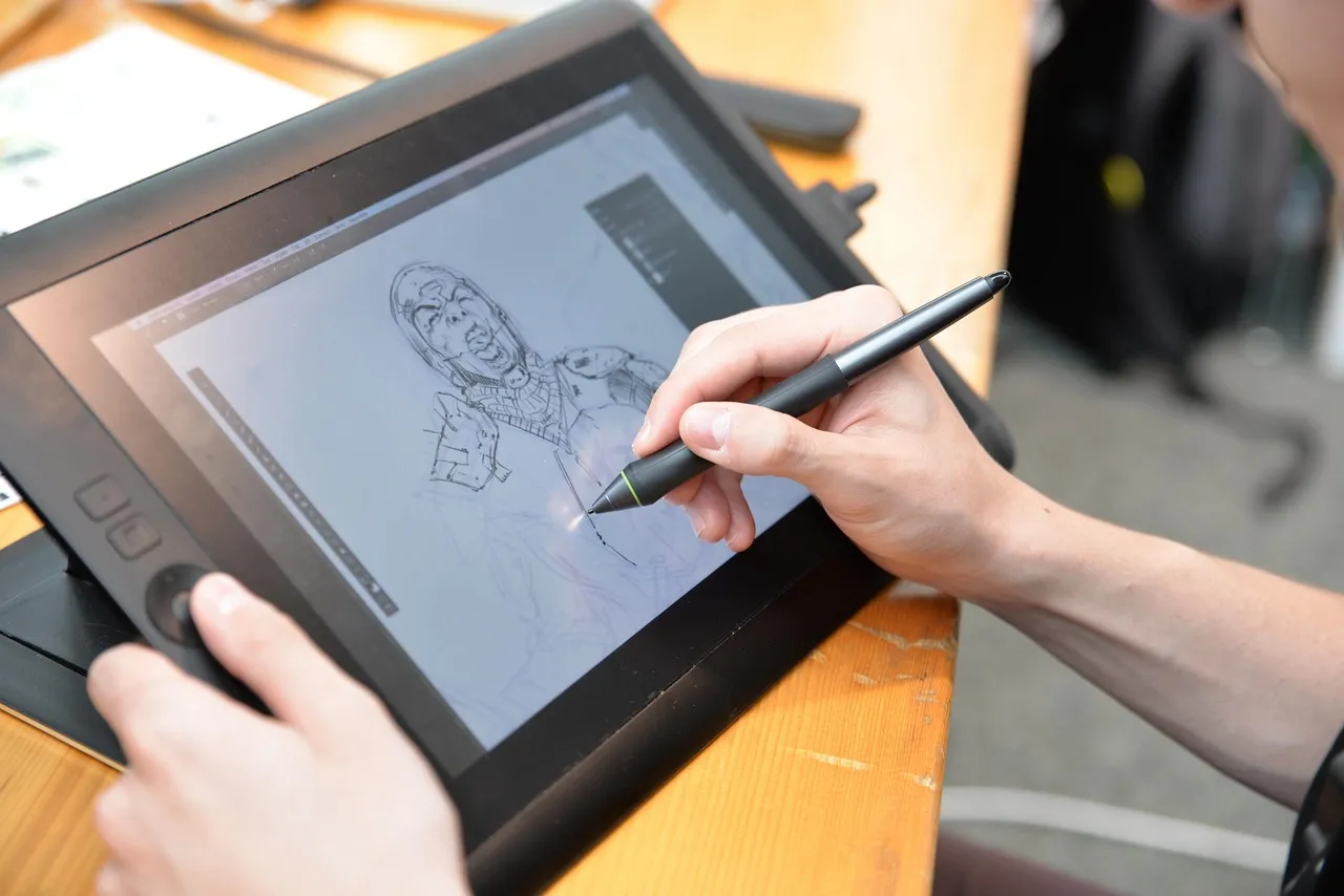 Hands drawing a sketch on a pen display